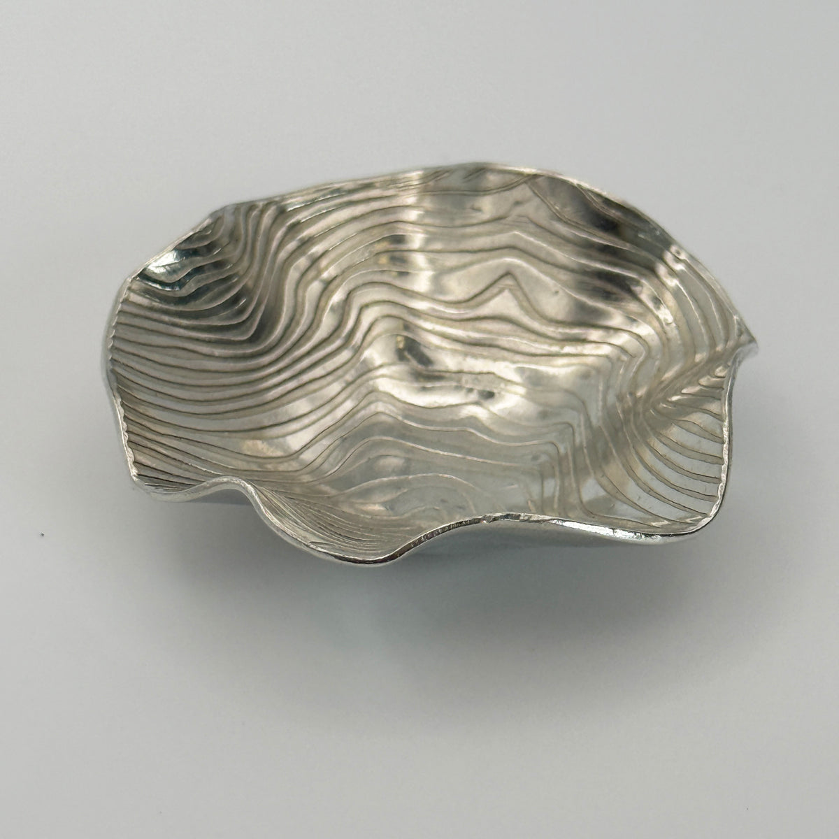 Rolled wave effect trinket dish with undulating edges